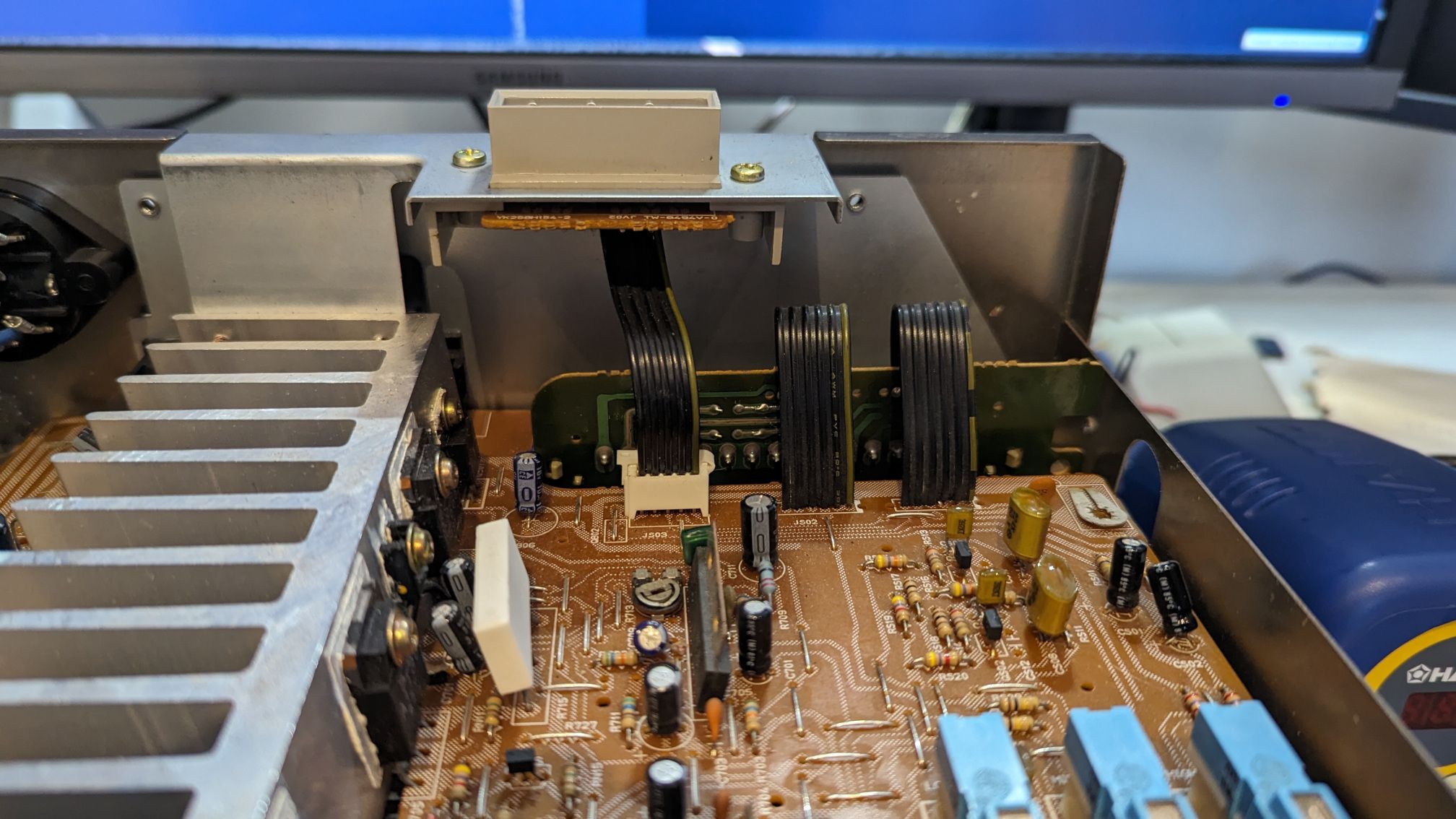 The amp PCB. with a beige connector at the top for the tuner, and the green vertical circuit board is for the bottom connector